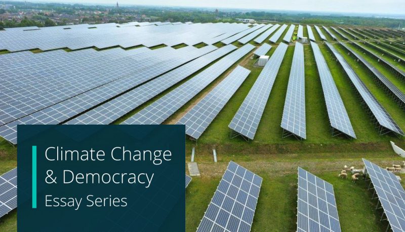 Climate Change & Democracy essay series. background photo shows an array of solar panels on a grassy field.