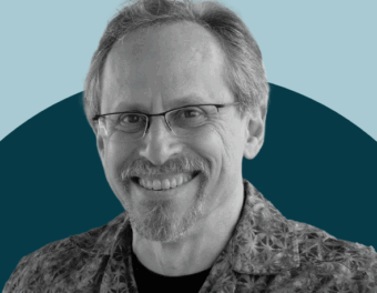 Mark Schwartz headshot on a two-tone blue background