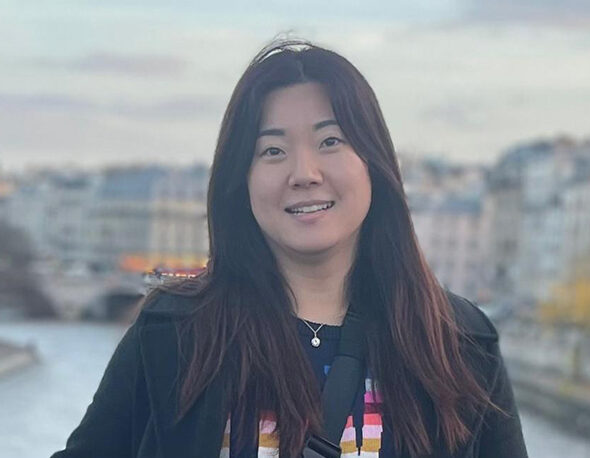 Headshot photo of Emily Kim outdoors in Paris